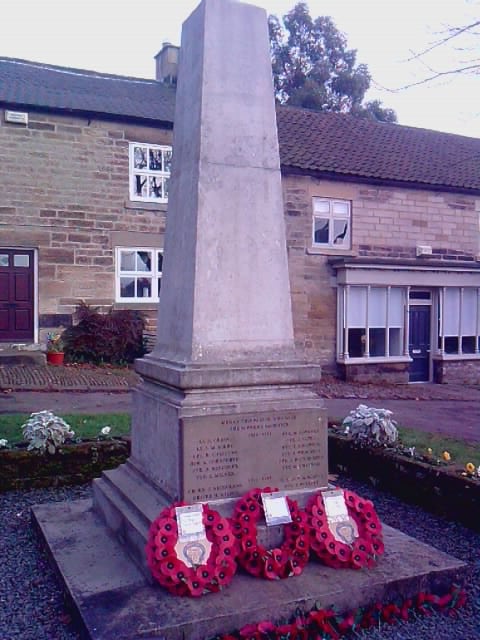 Wreaths of popies lying at the feet of a memorial