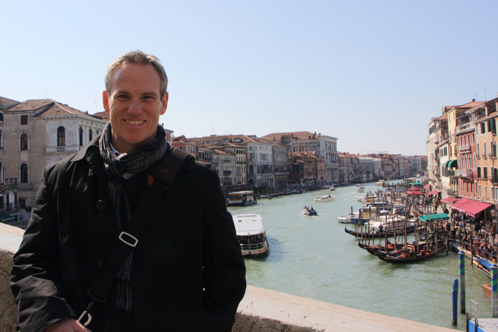 Teacher on the Rialto bridge in venice with the grand canal in the background