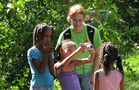 A student with local children on a Service Learning trip