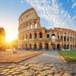 View of Rome Colosseum with sun shining behind