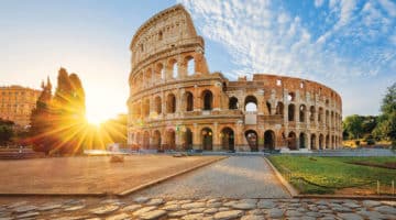 View of Rome Colosseum with sun shining behind