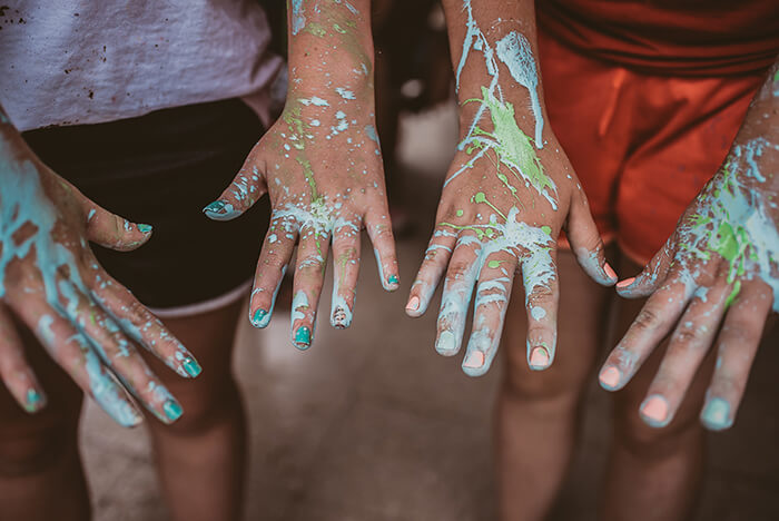 Hands covered in paint from service project