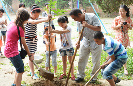 Students and local children planting trees in China