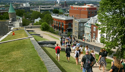 Group walking through Place d'Youville in Canada