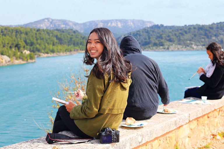 Student participating in France painting activity