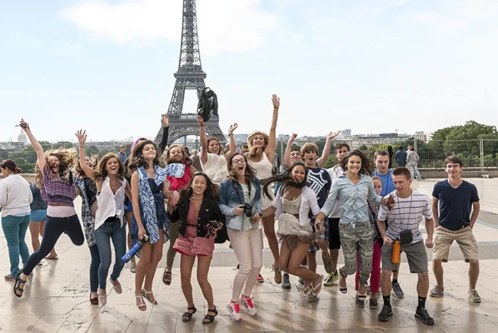Students jumping in front of the Eiffel Tower