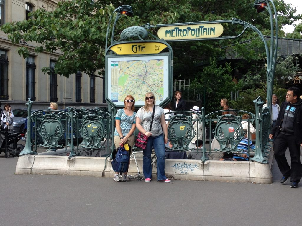 Participants posing in front of a Paris Metro entrance