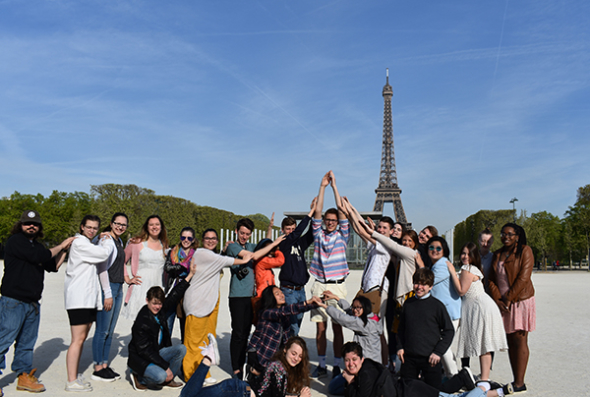 School group posing in front of the Eiffel Tower
