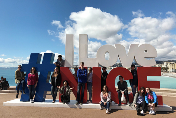 Students pose with an I Love Nice sculpture