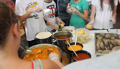 Students participating in a Spanish cooking lesson
