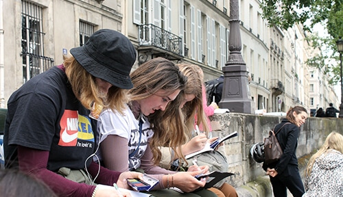 ACIS students water coloring in Paris