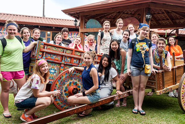 ACIS group posing around a Sarchi ox cart