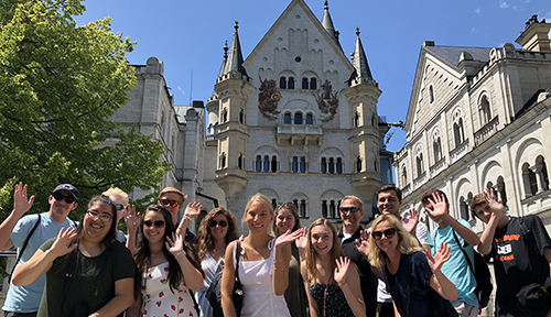 Students pose in front of Neuschwanstein Castle