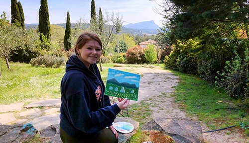 Student holding her Cezanne inspired painting