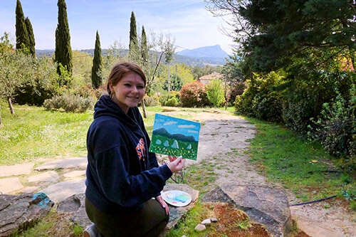 Student holding her Cezanne inspired painting