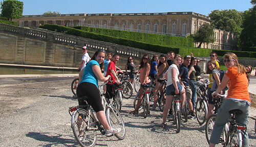 Students on bikes at Versailles gardens
