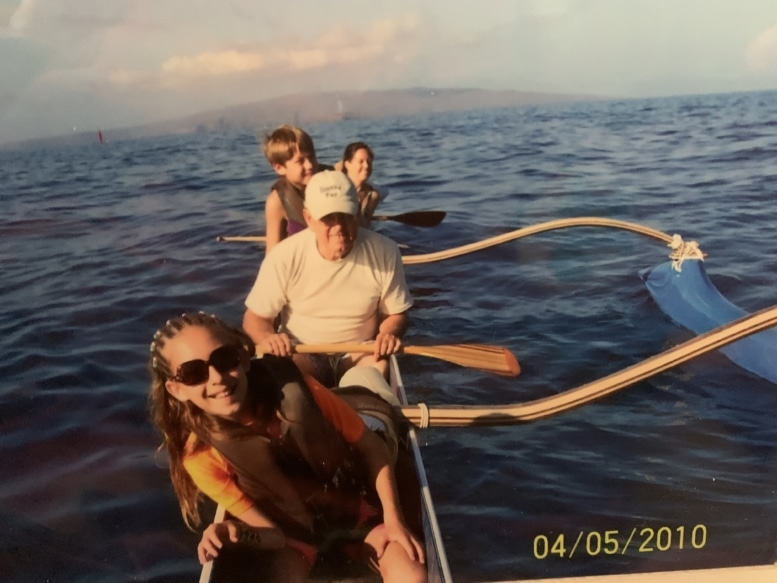 family on a canoe with outrigger