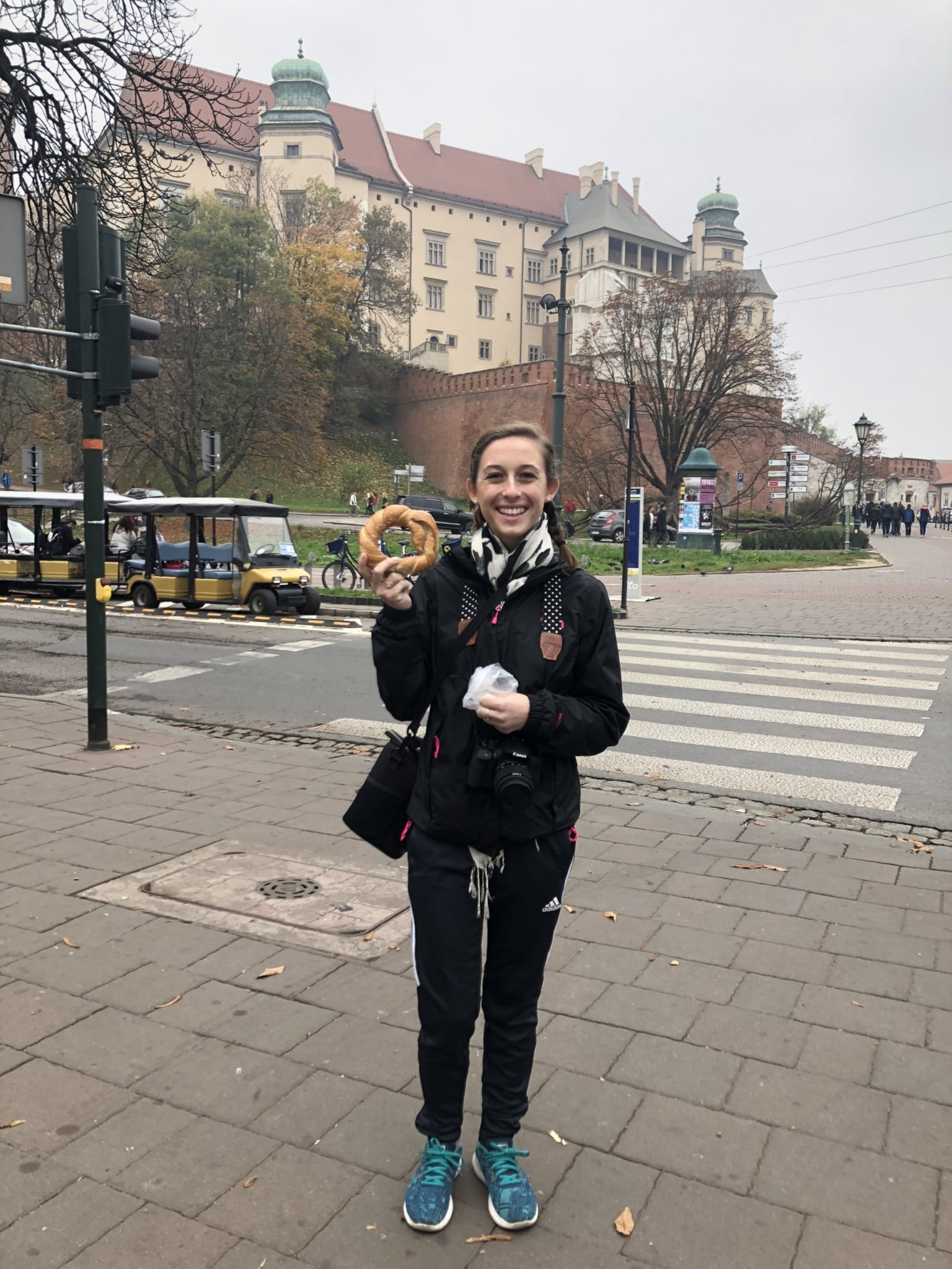 young lady holding a pastry during a trip