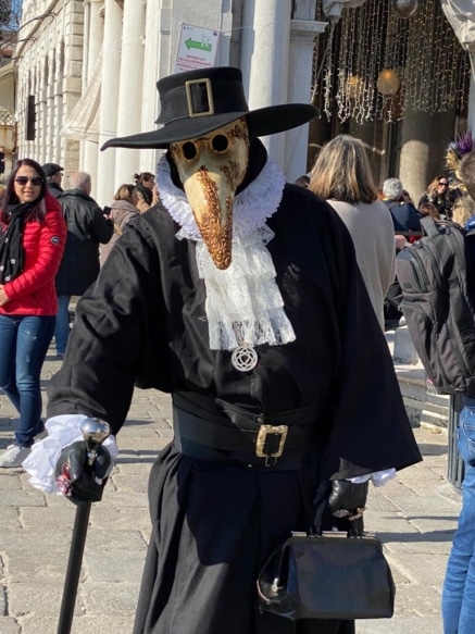 A person wearing a costume of a Medico della peste (Plague doctor) 