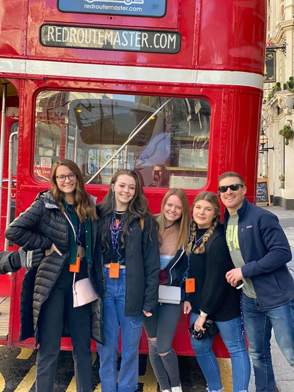 Scott and students in front of a London bus