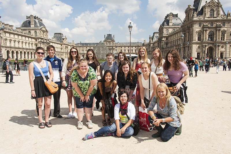 Group posed in front of the Louvre