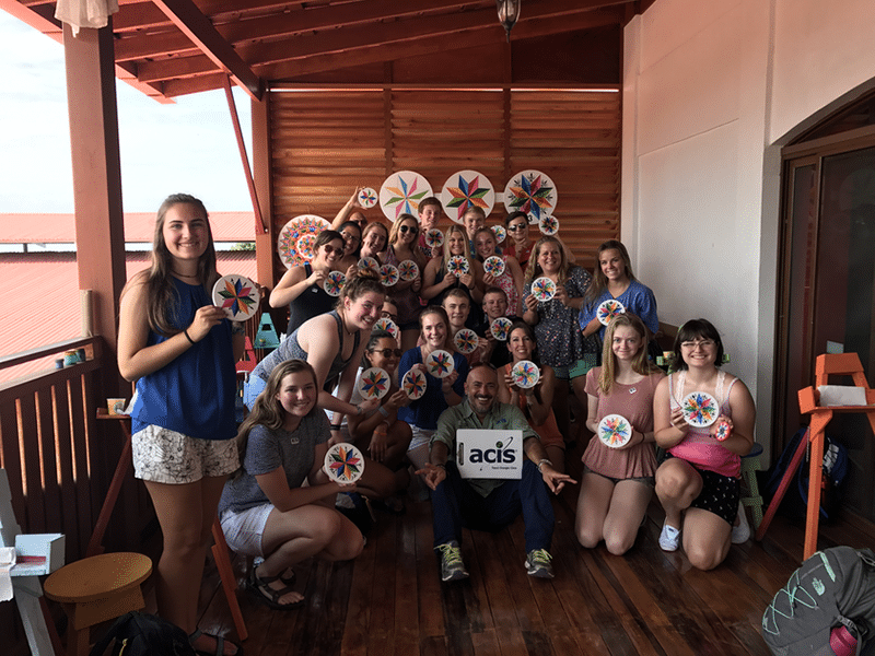 Student group pose with their painted Sarchi souvenirs