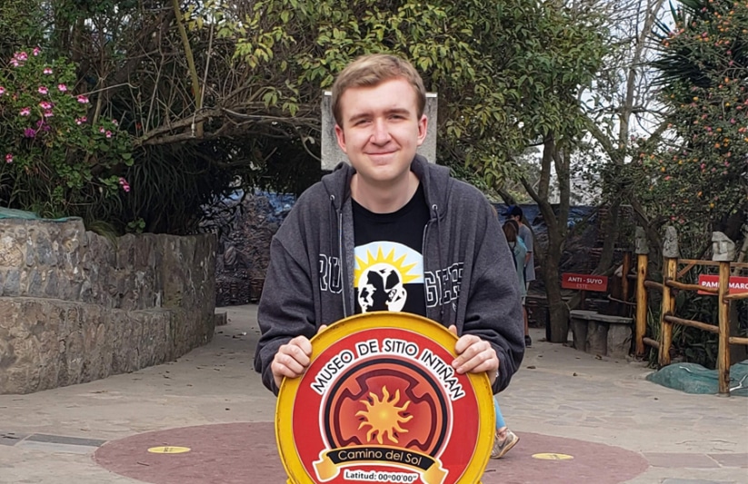 ACIS Student stands on the equator