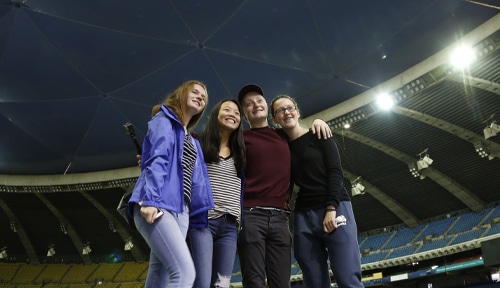 Small group posing inside the Olympic Park Stadium