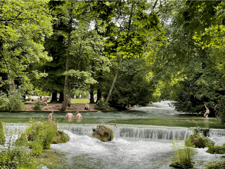 Group swimming in the Eisbach River in Munich
