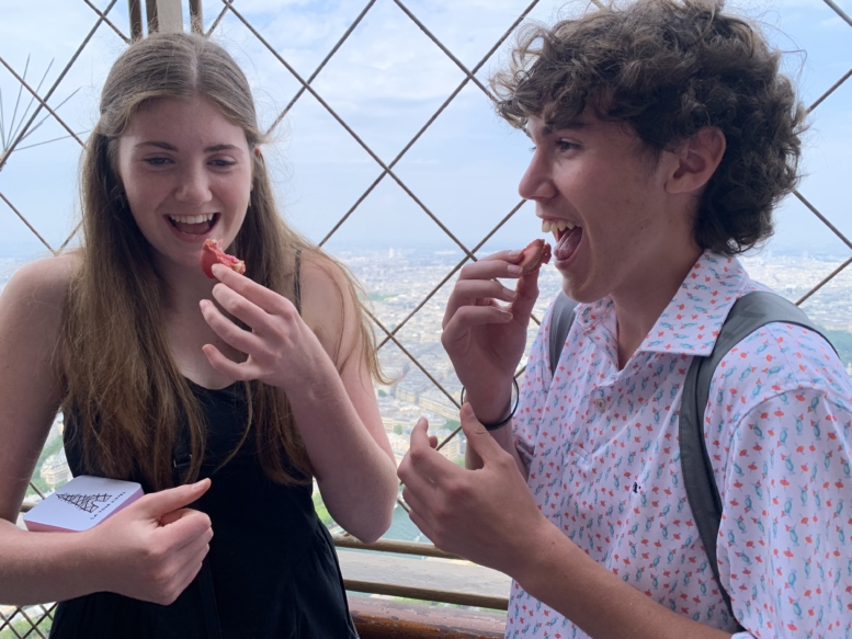 Students eating macarons at the Eiffel Tower