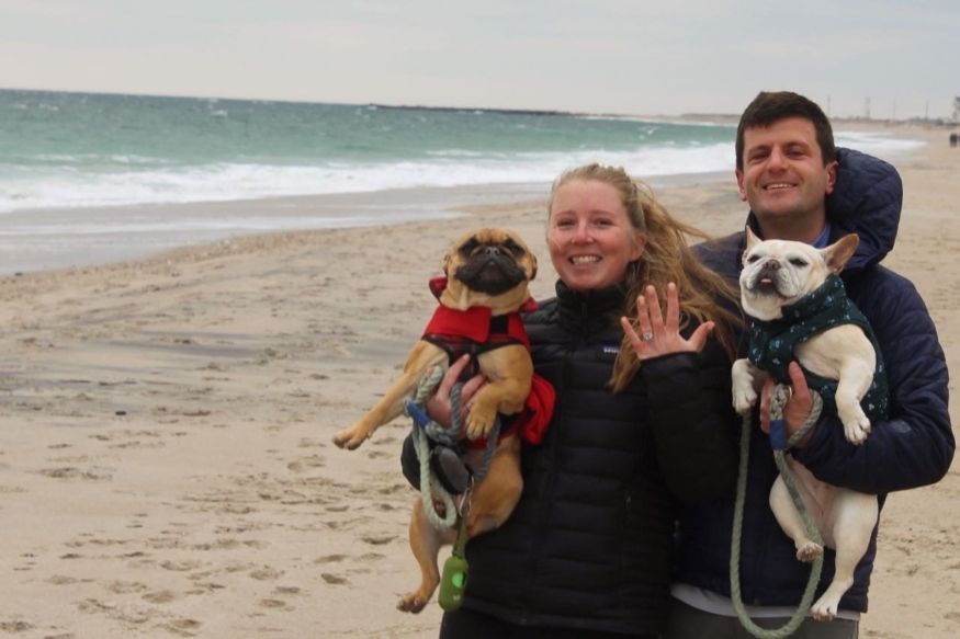 Bridget on the Beach with her fiancee and two bulldogs