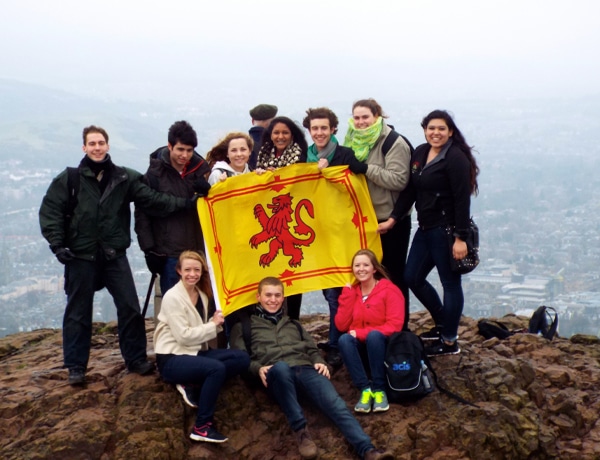 Group at Arthur's Seat holding the Royal Banner of Scotland in Edinburgh