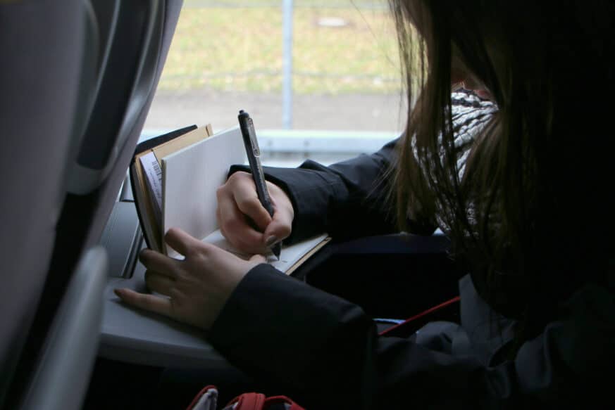 Student journaling on the bus