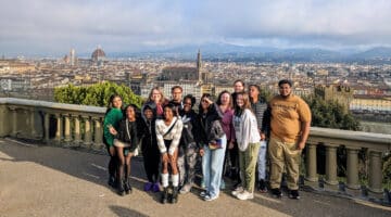 A group of students posing in front of the Florence cityscape