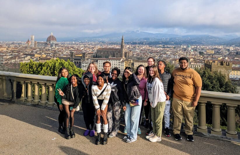 A group of students posing in front of the Florence cityscape