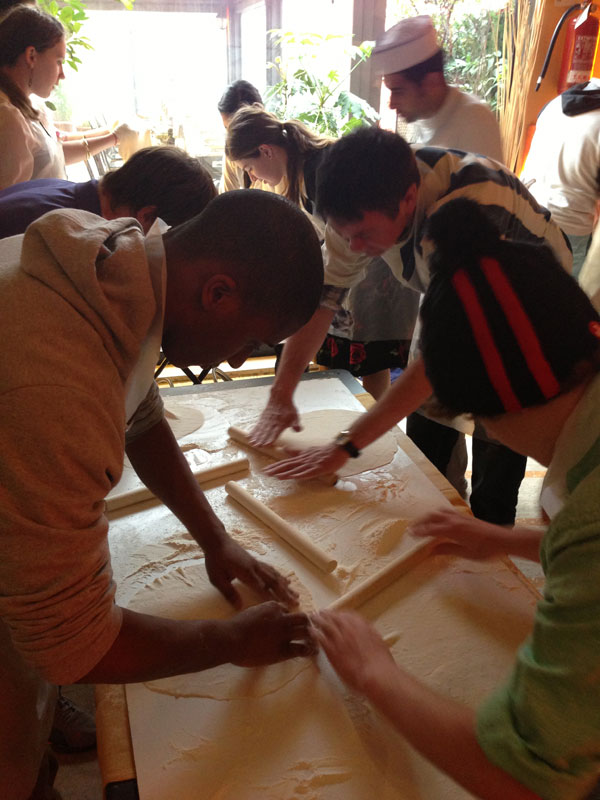 Students at a pizza making class in italy
