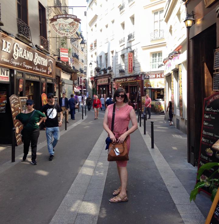 Teacher standing in narrow pedestrian alley in Paris
