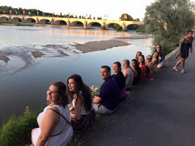 elizabeth zingales and students by the river