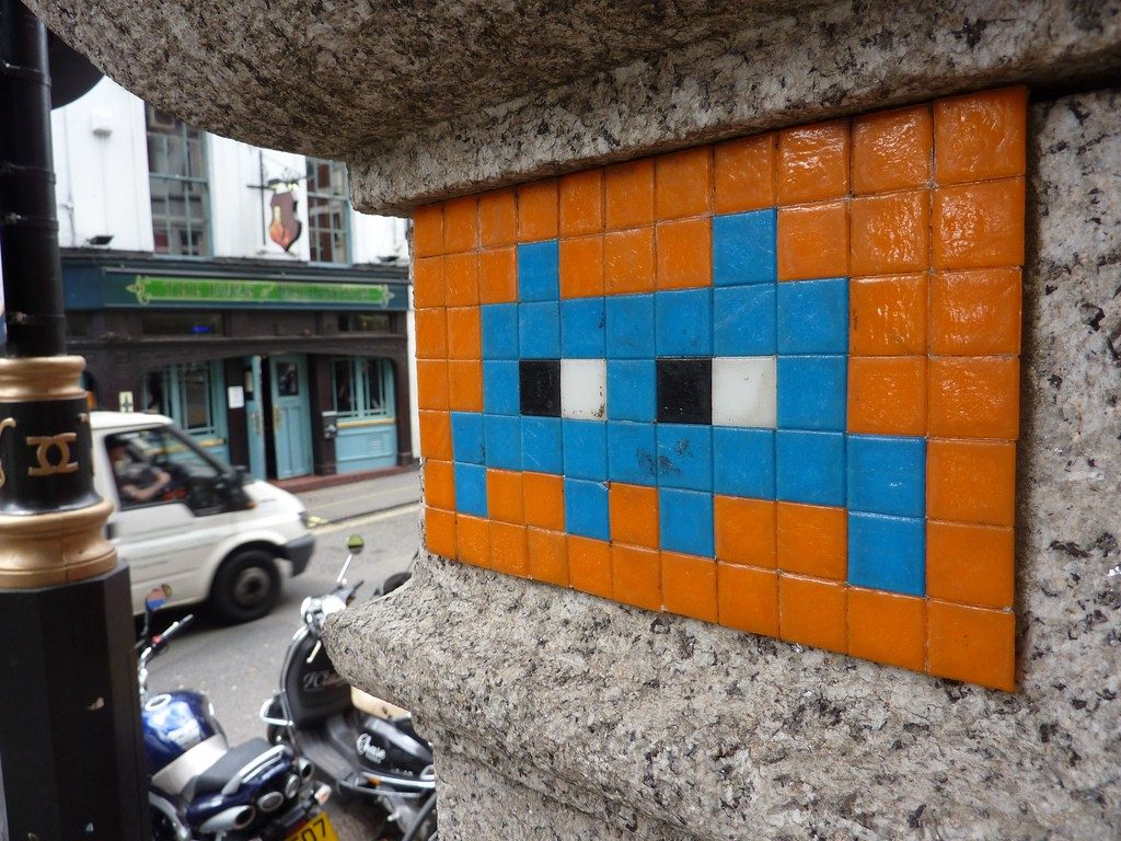 A tiled graffiti in London depicting an arcade space invader