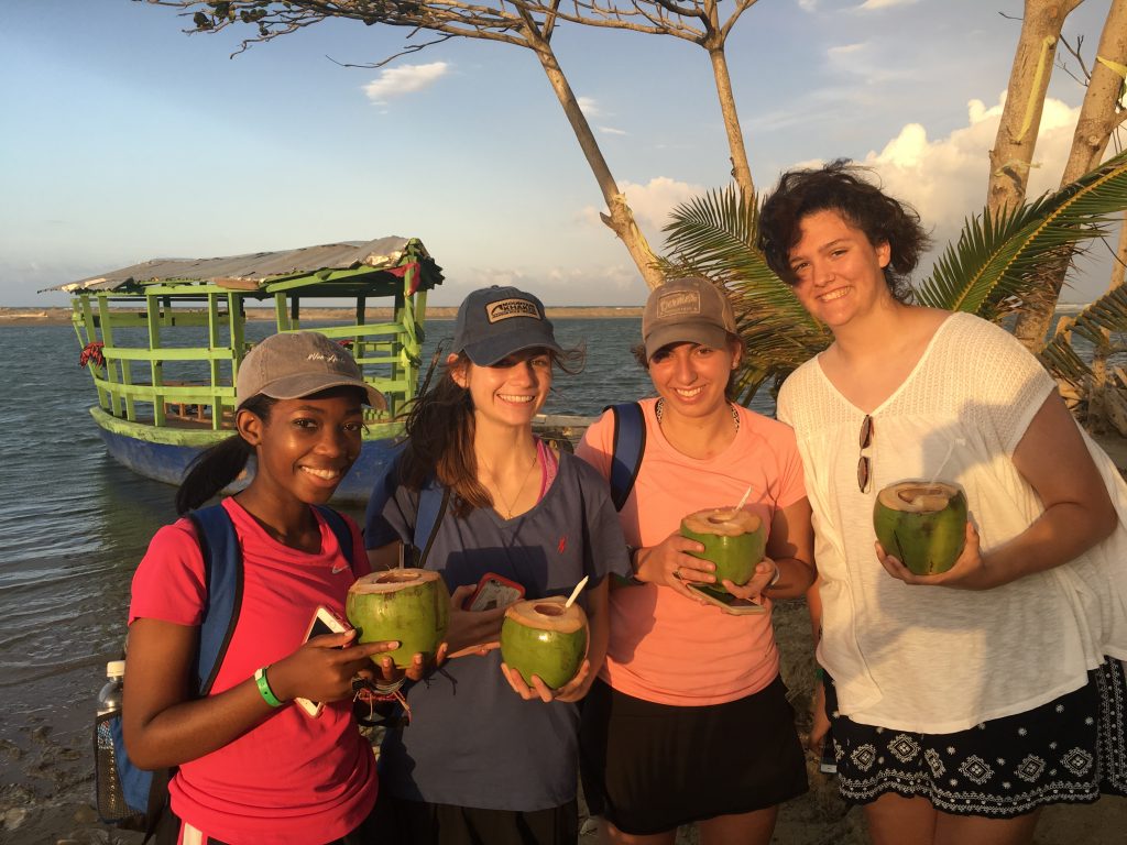 Students drinking from coconuts at sunset in the Dominican Republic.