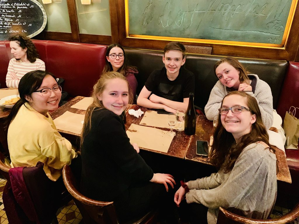 An ACIS group of students at a table 