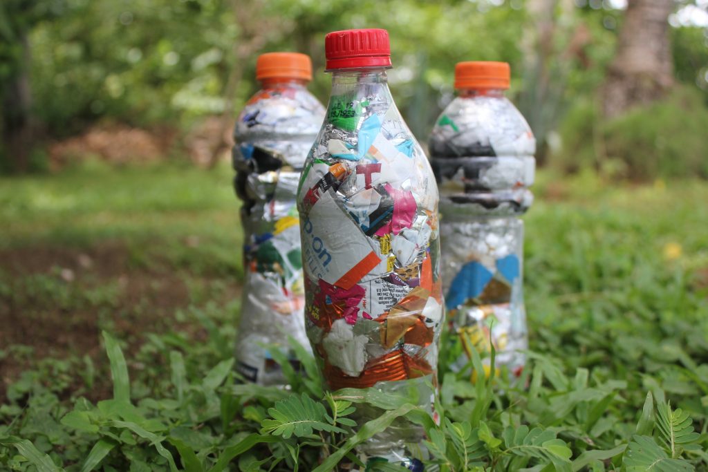 Plastic bottles stuffed with plastic wrappers to be used as eco-bricks, or building material.