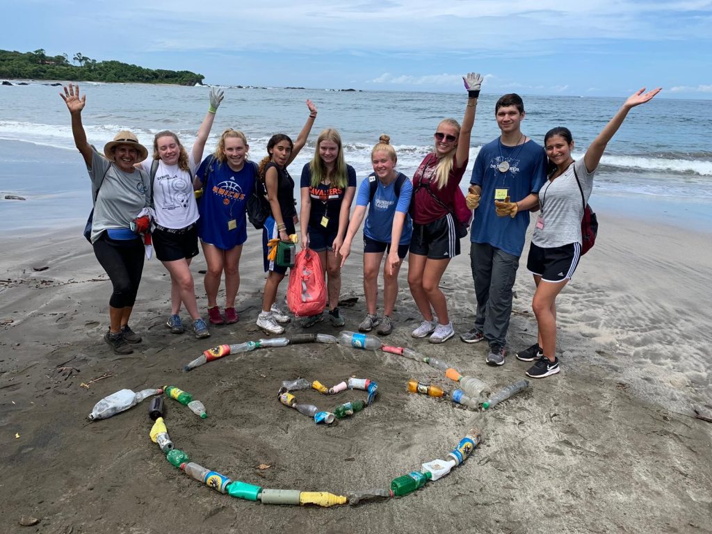 A group of students celebrate their day of beach cleanup in Costa Rica